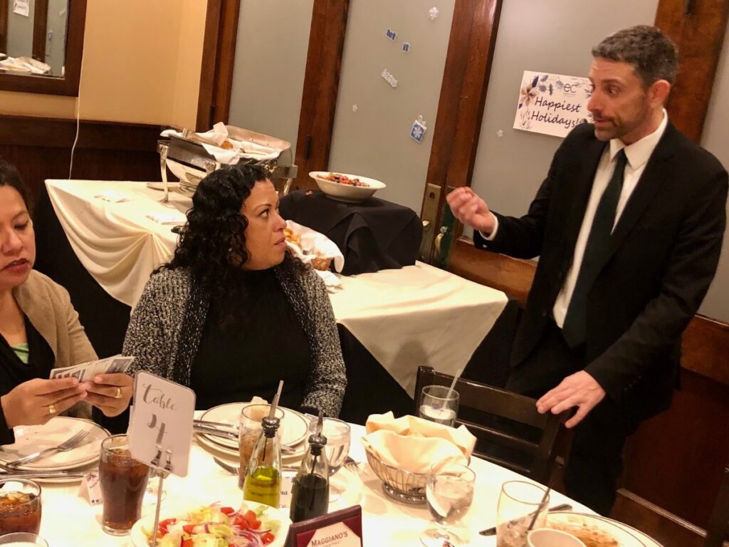 Nick Gasparro performing close-up magic for guests at a private in-home dinner party in the Chicago suburbs