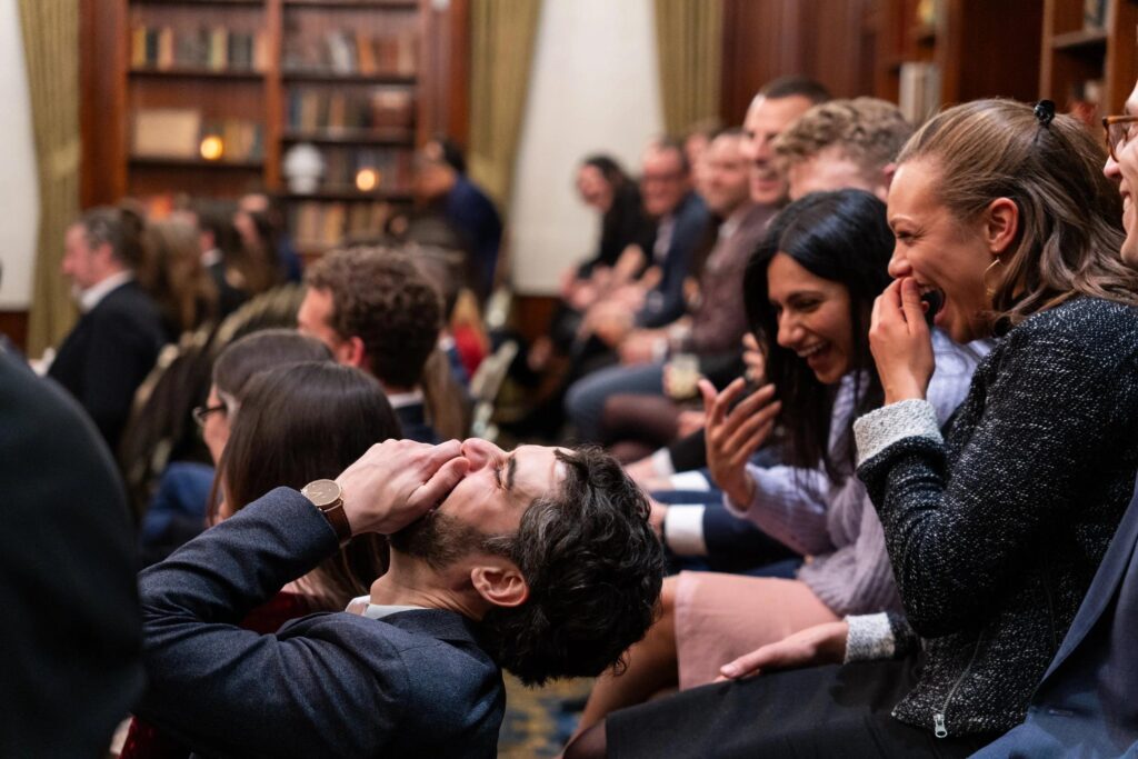 Guests reacting to a mentalism routine during a live show