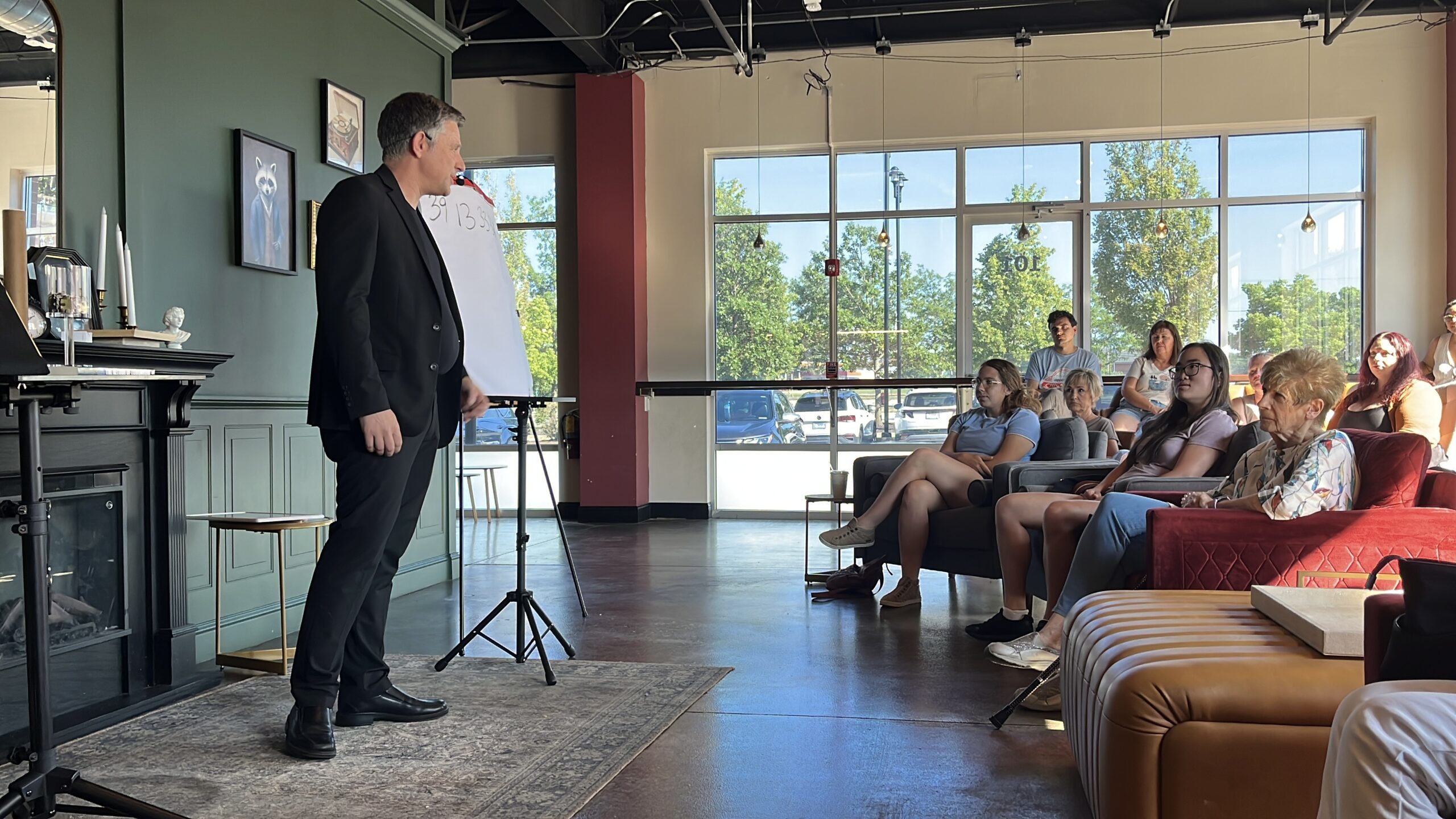 Magician and mentalist Nick Gasparro performing close-up magic for a group of adult guests