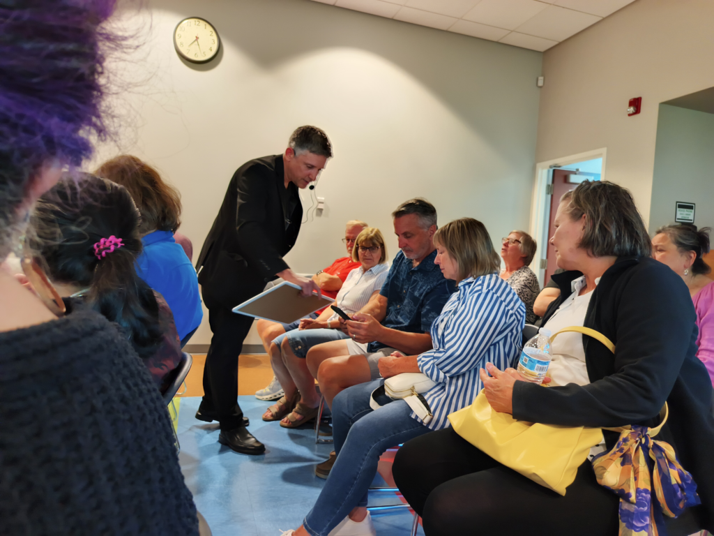 Close-up magician performing corporate entertainment in Tinley Park for a small group of guests
