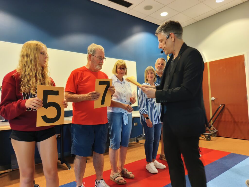 Nick Gasparro revealing a predicted number during a mentalism performance at Hanover Park Library