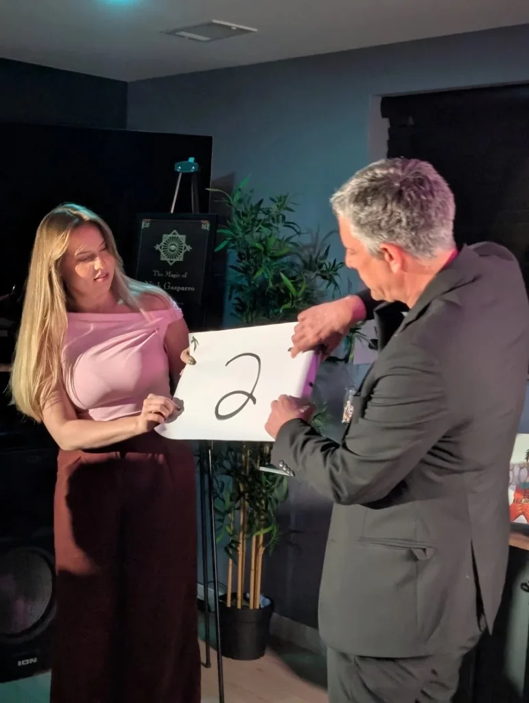 Nick Gasparro revealing a mentalism prediction with a guest at a wedding reception near Chicago